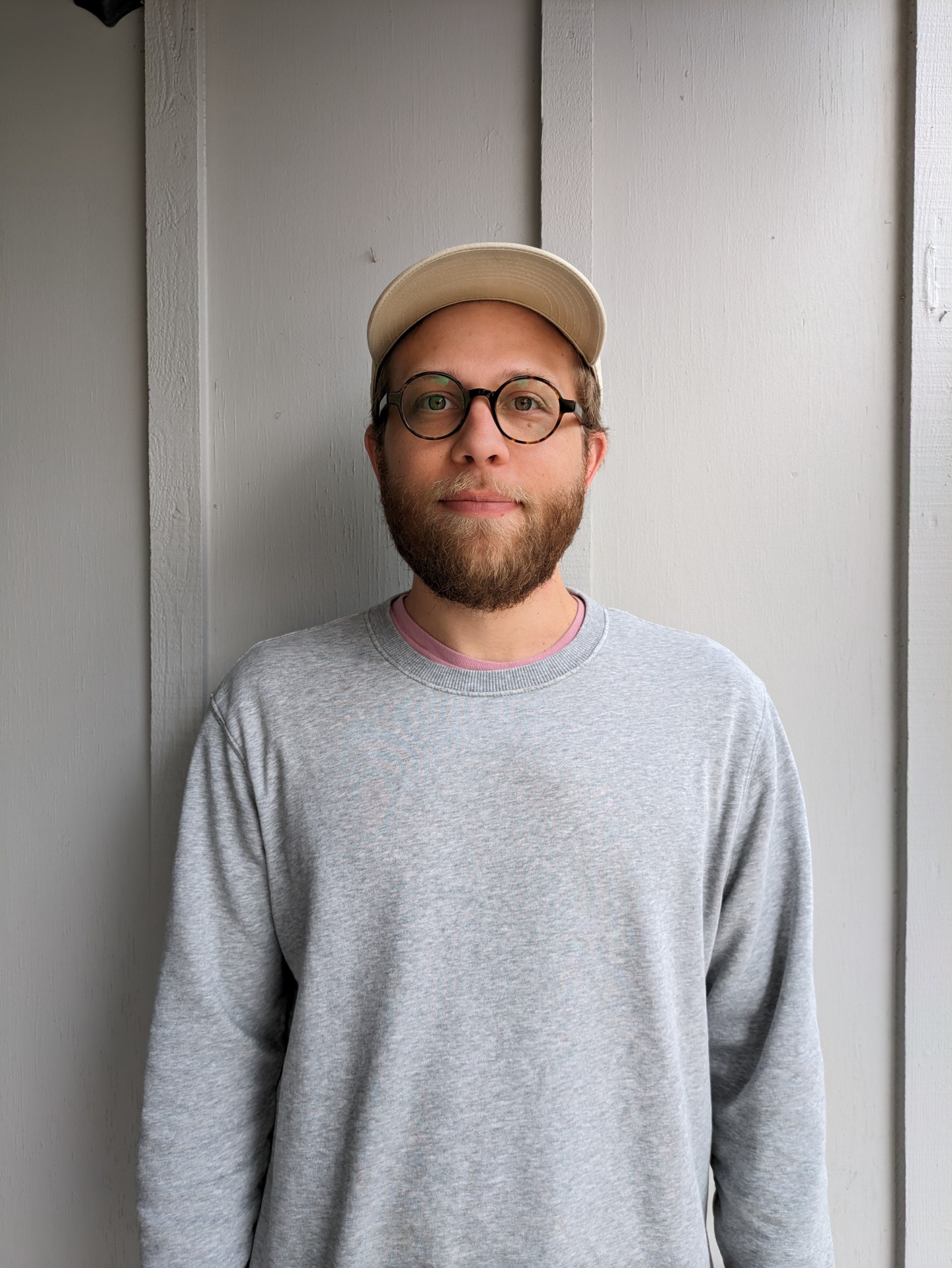 Ryan Doucette wearing a cap and glasses
